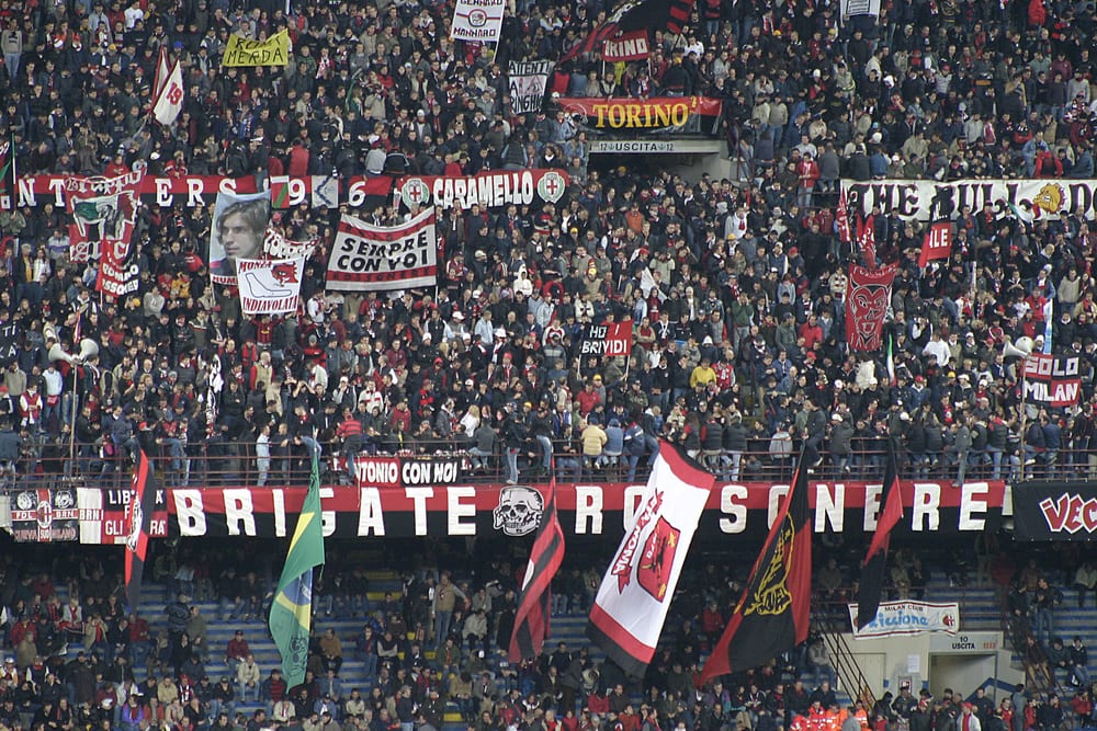 Italians supporting A.C. Milan at an Italian soccer match