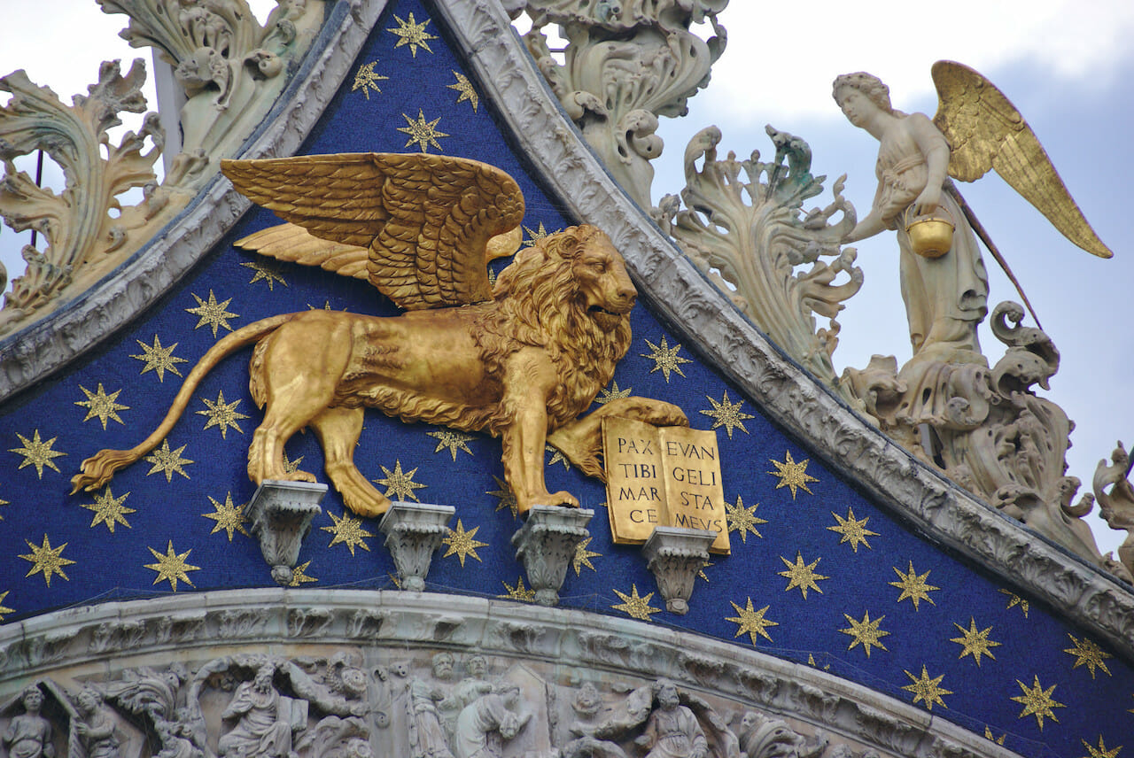 Venetian winged lion, a symbol of Venice, in gold on a building's facade