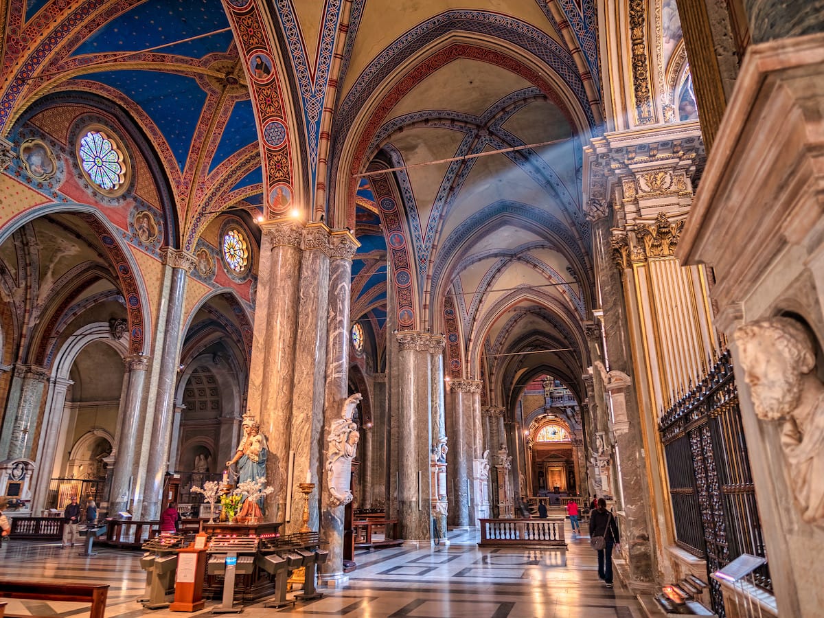 Santa Maria sopra Minerva interior with ray of light and person walking by