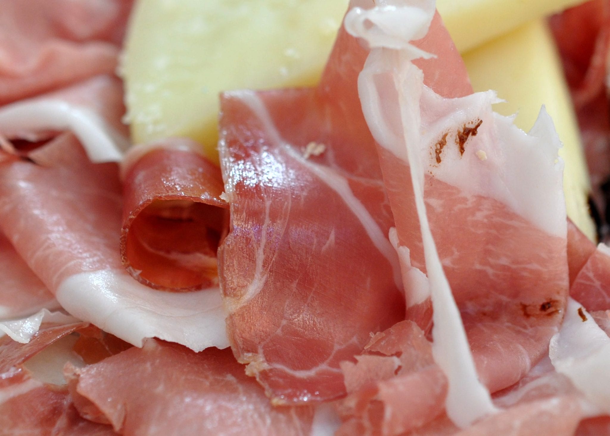 Two DOP foods of Italy: prosciutto crudo di San Daniele, and Parmigiano Reggiano