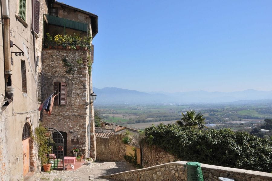 The Umbrian town of Narni is far from the train station Narni, Umbria, a rustic building in the umbrian countryside of italy on the left hand side, and the view of the rolling hills on the right