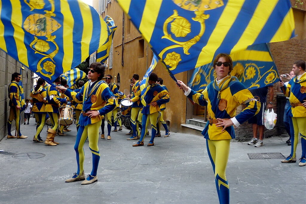 Flag bearers celebrating the winning team in the Palio di Siena in Tuscany with typical costume