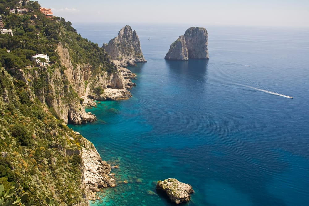 Famous Italian attractions include the Faraglioni rock formations in Capri along the Amalfi Coast. 