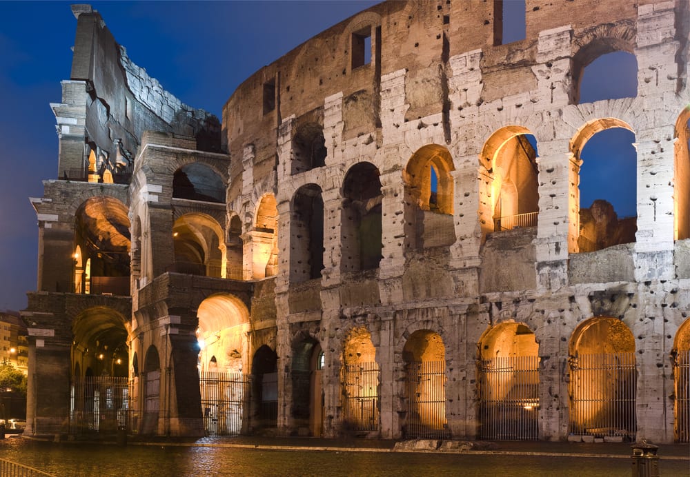 the outer walls of the colosseum at night 