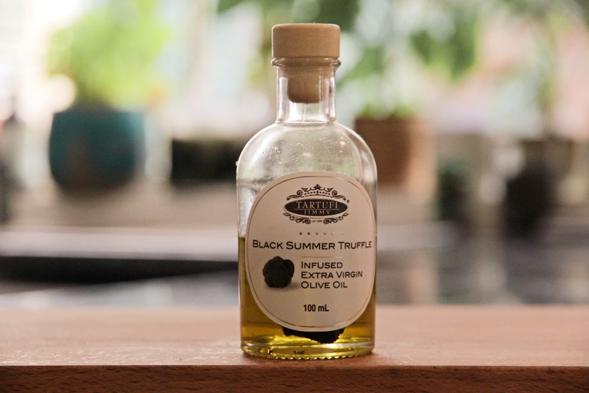 A glass bottle filled with truffle oil. 