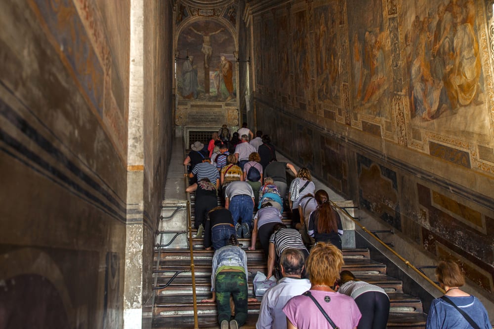 people kneeling on sacred steps - the scala sancta - in rome