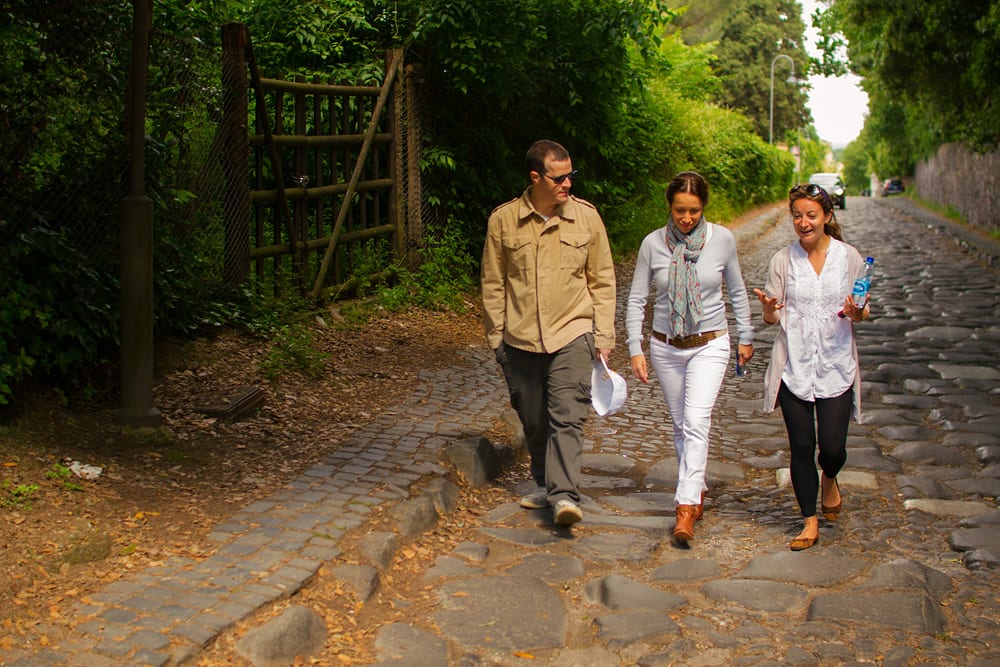 Visitors walk on the Appian Way.