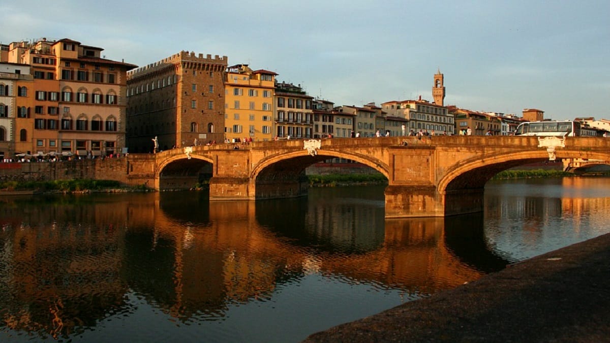 sunset light on bidge connecting an old town