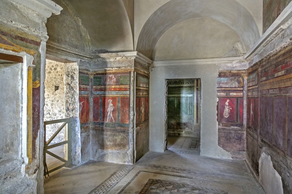 Pompeii frescos and arched walls.
