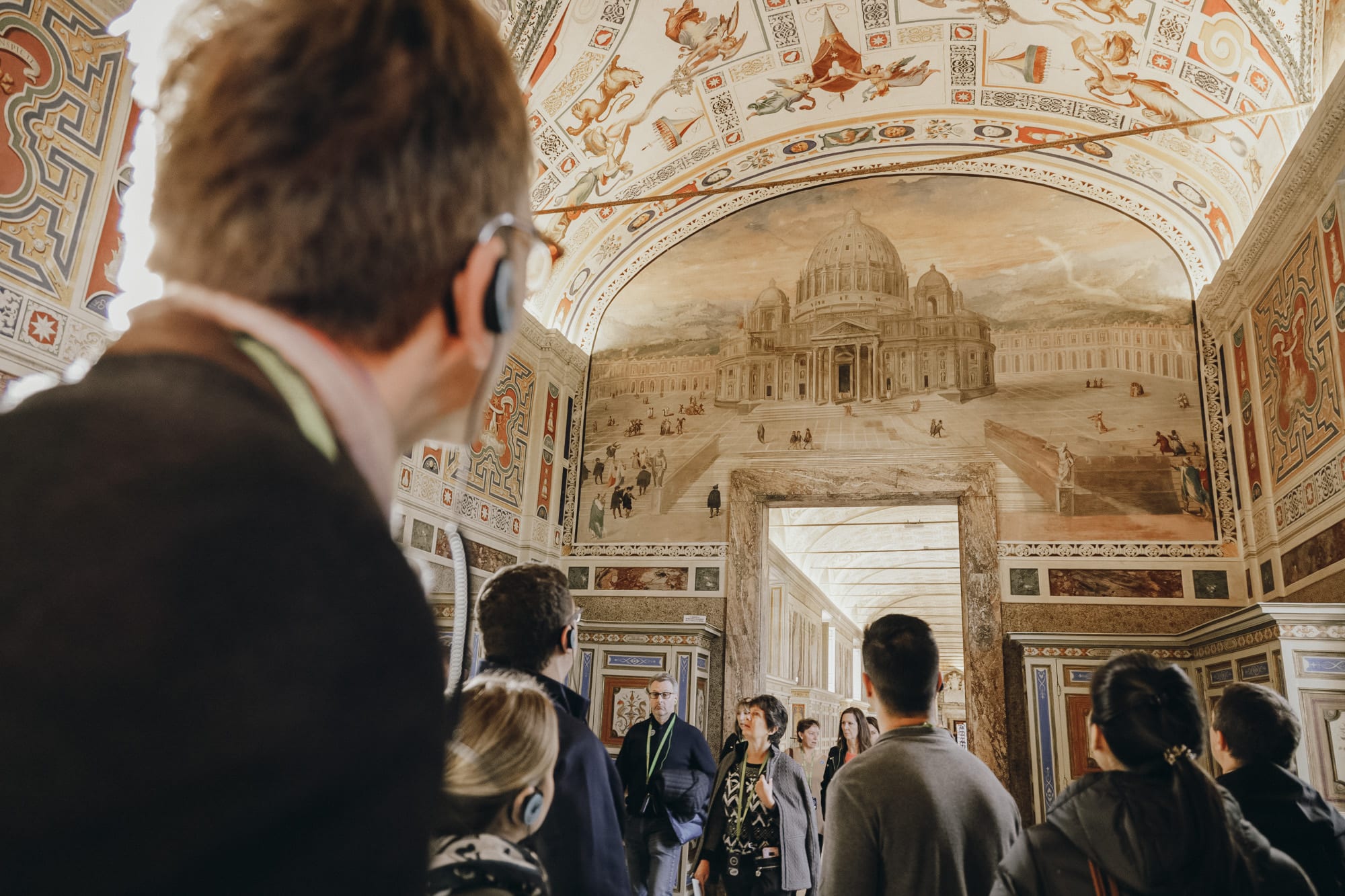 Tourist visiting the Vatican Museums and admiring extraordinary frescoes