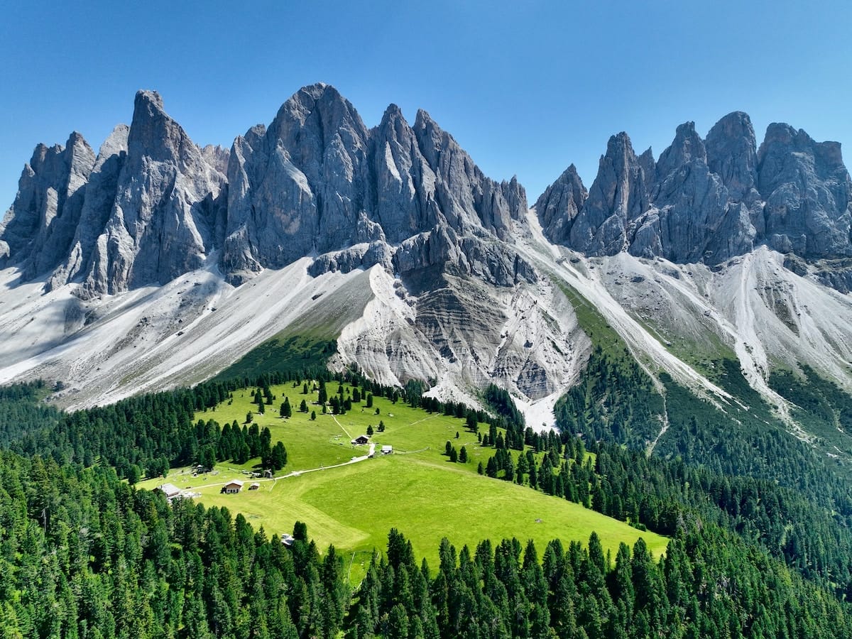 mountains and green field with blue sky bressanone brixen