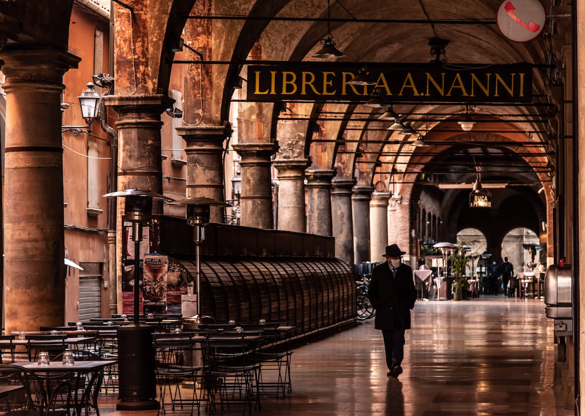 Architecture and sign with man walking in Bologna Italy
