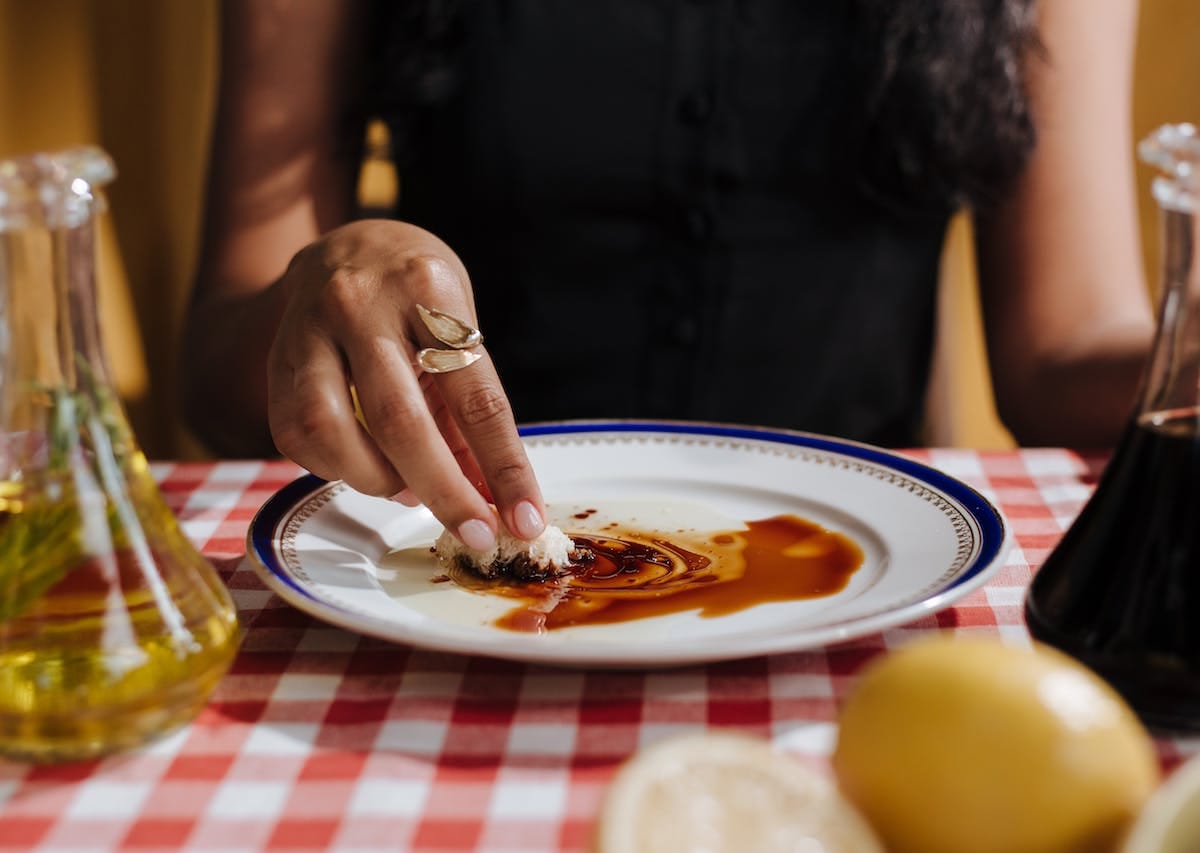 woman eating balsamic vinegar and Italian oil