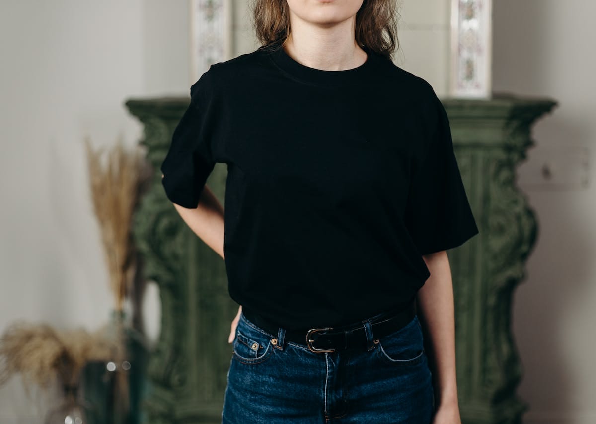 person wearing black t-shirt and denim jeans