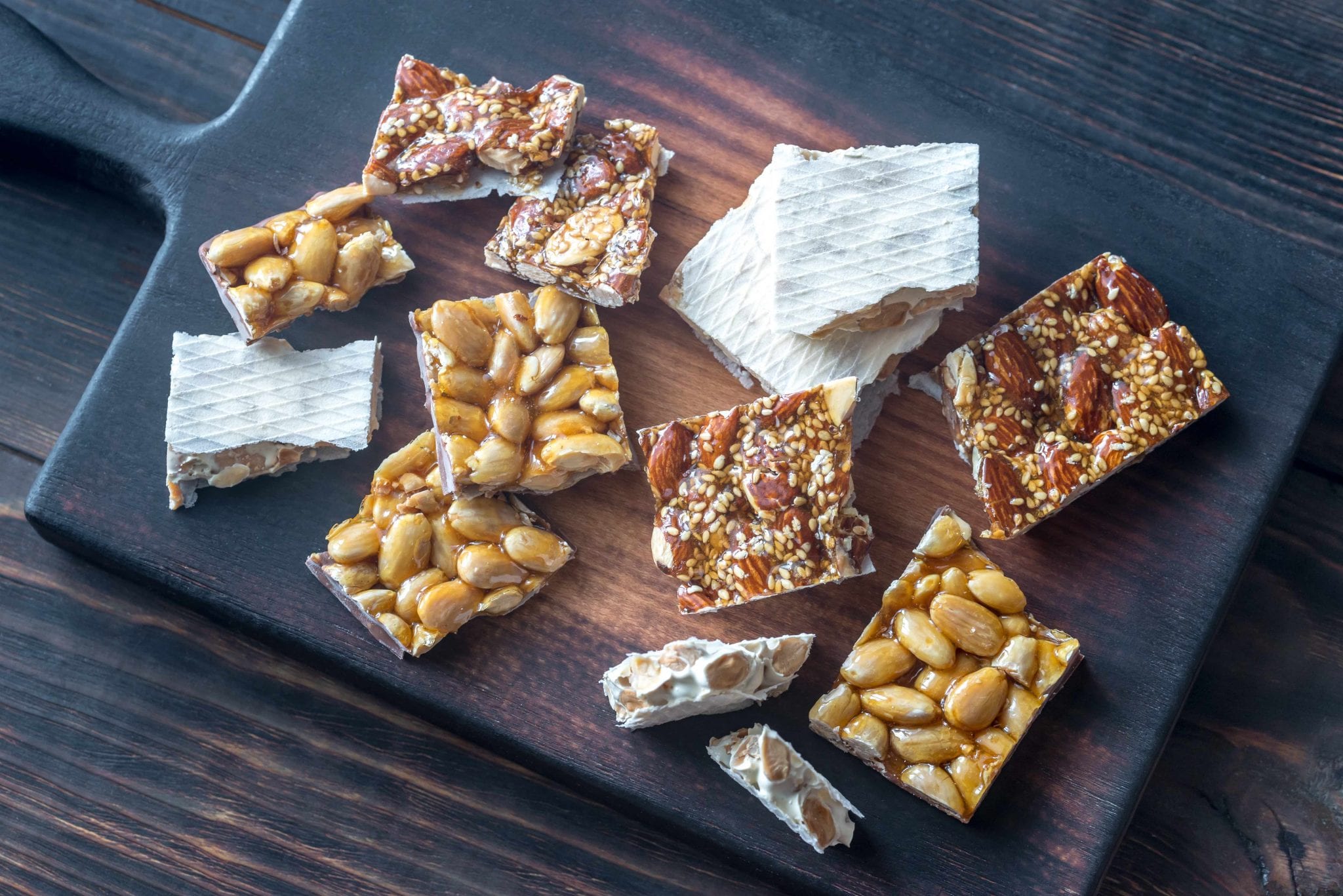 Slices of turron on the wooden board | Source: Stock image