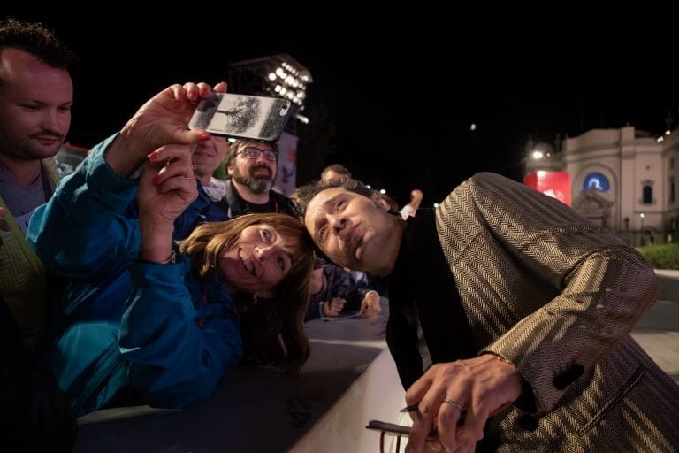 Actor Claudio Santamaria poses with a fan at the Venice Biennale