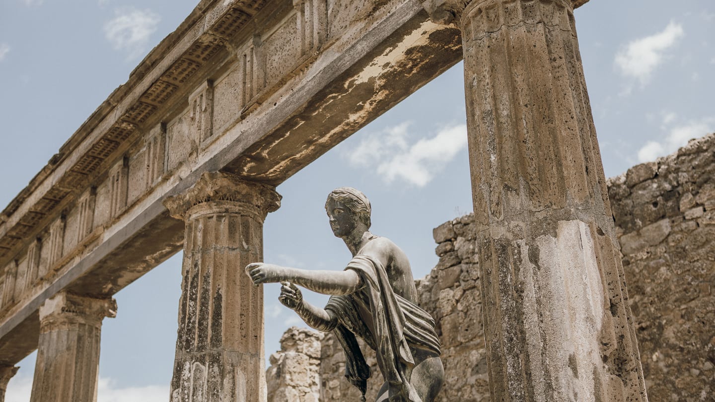 Statue and columns at the ruins of Pompeii