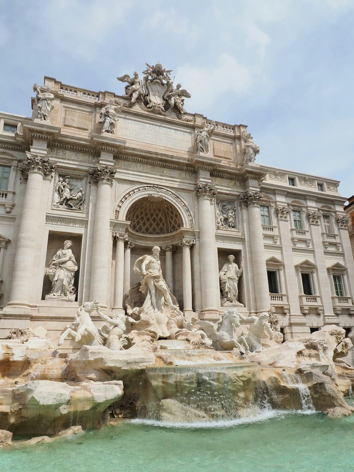 Rome's Trevi Foutain with three statues standing over the water.