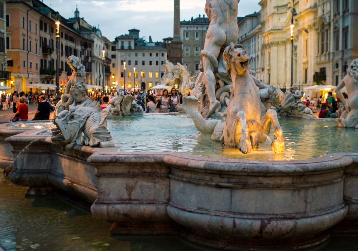 A large fountain in Rome's Piazza Navona with various statues in the water.