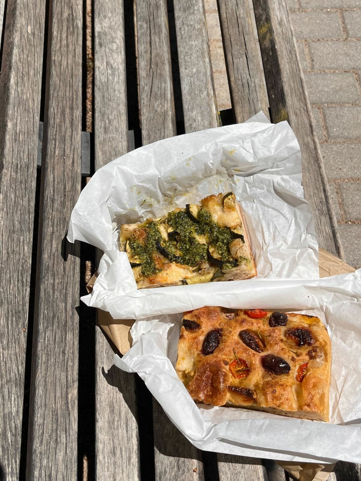 Two pieces of focaccia, one of the most iconic foods to try in Italy
