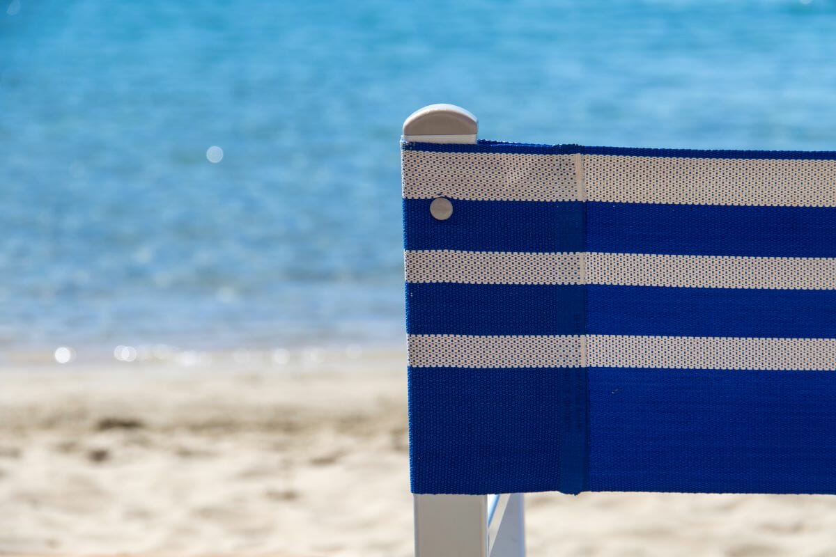 A view of a beach chair with the sea in the background