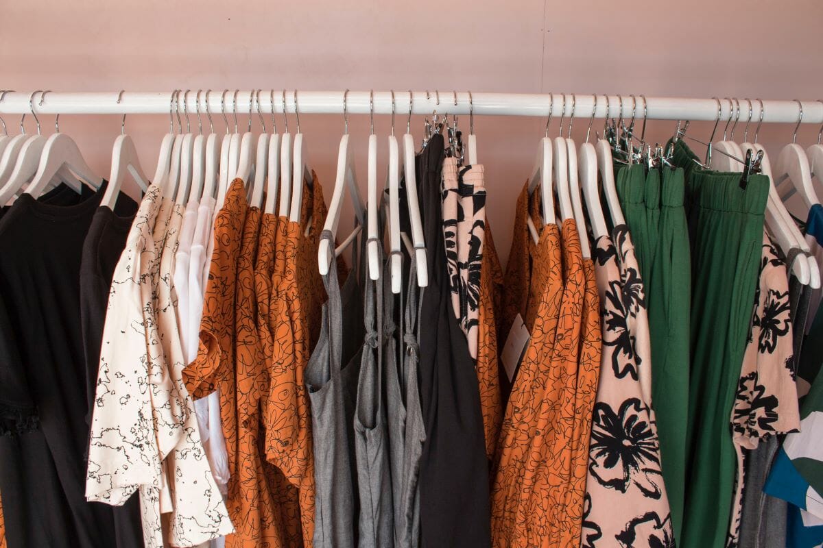 Clothes hanging on hangers inside a shop