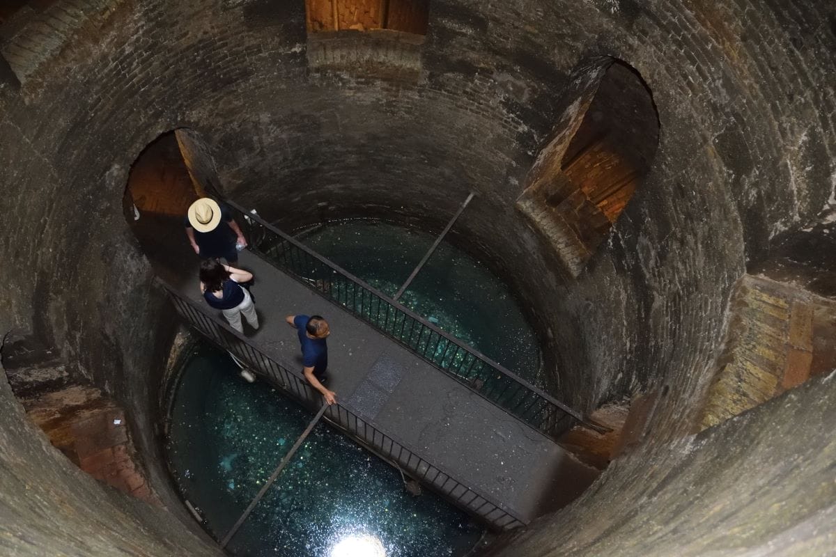 people exploring a well