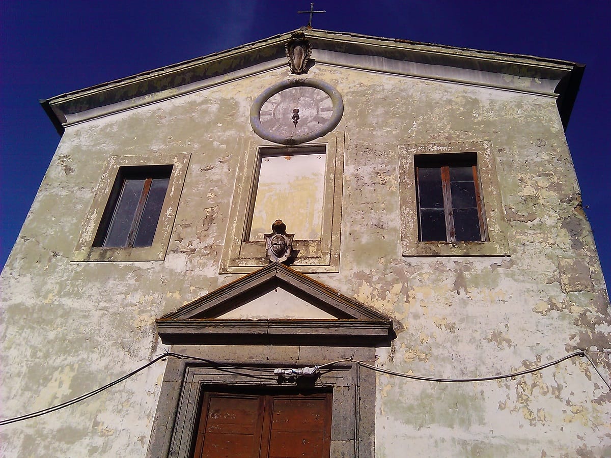 building with slanted roof, two windows and a door