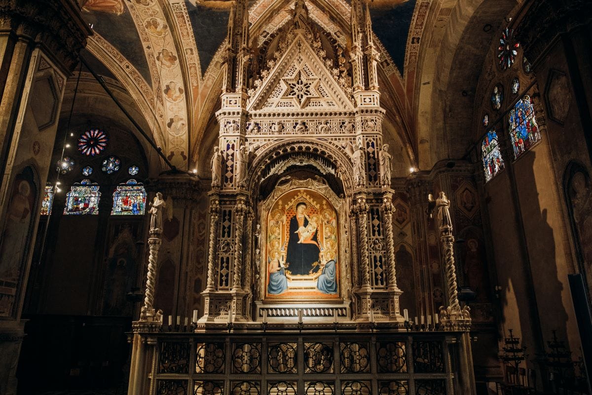 An example of artwork in Florence of a Mary and Jesus image on an ornate alter.