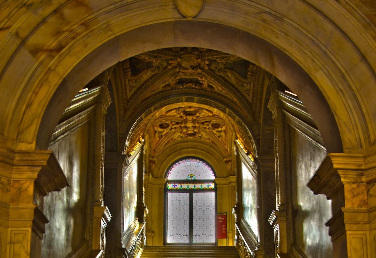 The Golden Staircase (Scala d’Oro) inside the Doge’s Palace in Venice, featuring ornate gold-leaf ceilings, marble arches, and intricate Renaissance detailing.