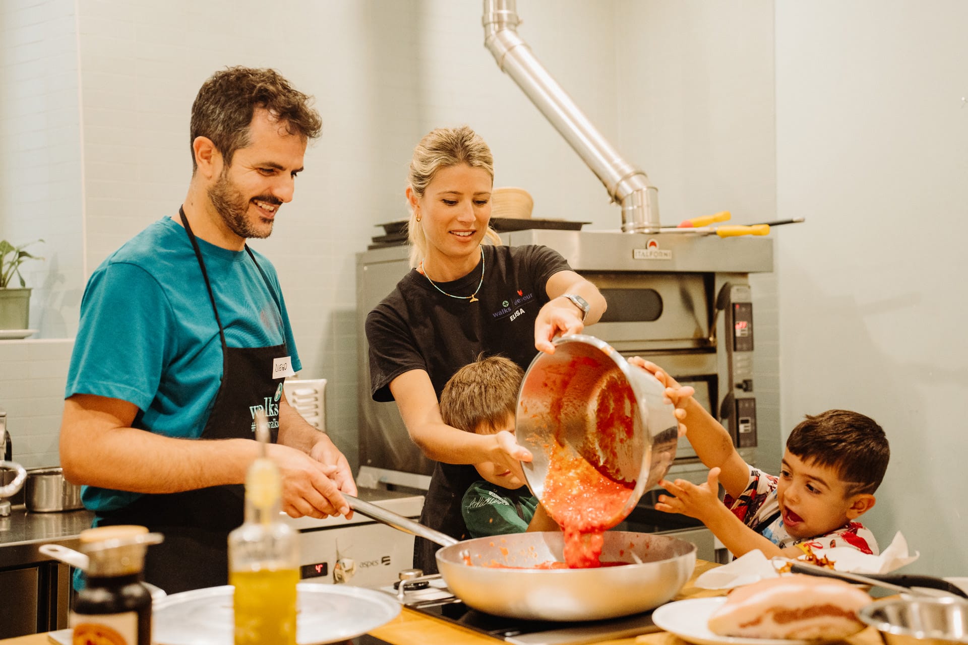 A family pours homemade tomato sauce into the pan in a pasta making in rome