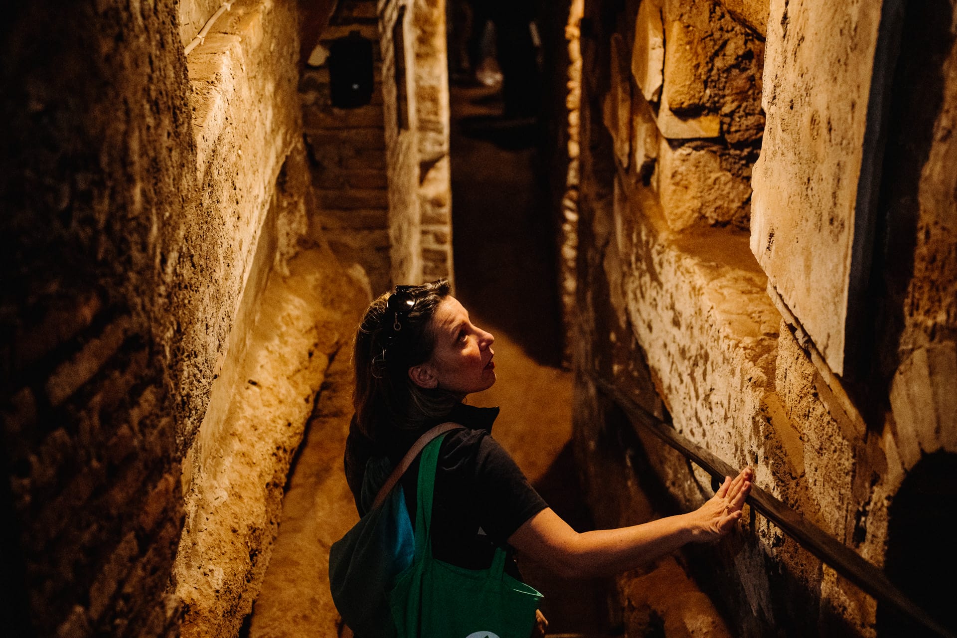 A women in one of the underground passageways of the catacombs in Rome