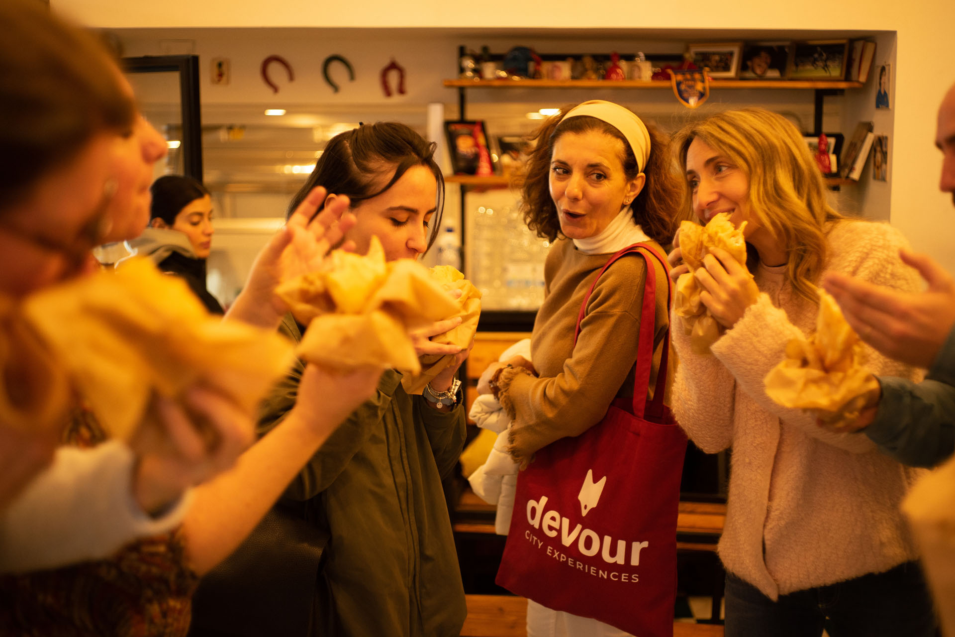 A tour guide with a group of guests having a taste of folded pizza in Napoli